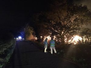 Fire fighters assess the scene of the fire