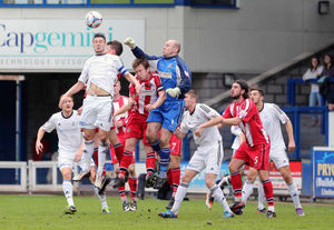 Simon Grand of AFC Telford United challenges with Stuart Coburn of Altrincham for the ball at this Telford corner