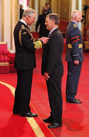 Mel Evans receives his MBE from Prince Charles.