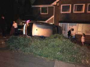 Vauxhall Astra on its side in a resident's driveway in Dovedale Road, Wolverhampton