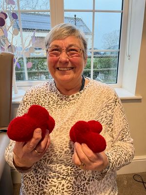 Volunteer Sharon Smith with some of the crocheted hearts she made for patients at St Giles Hospice