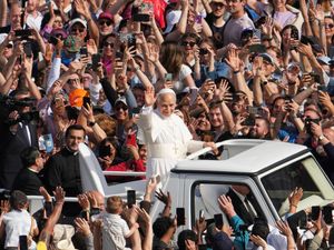 Pope Leo XIV greets jubilant crowds from the popemobile ahead of the ceremony