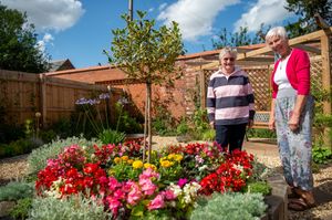Sue Whitcombe and Jacqui Roden in one of the open gardens at Copthorne Keep with a colourful floral display. Picture: Bellway