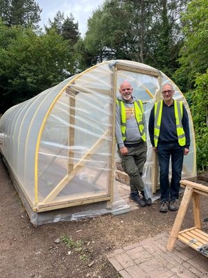 Jason Henley and Adrian Smith with the polytunnel.