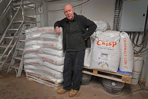 Head brewer Martyn Powell shows how much malt goes into the brewing process