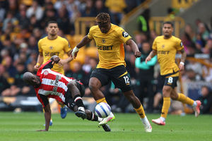 Yoane Wissa of Brentford battles for possession with Emmanuel Agbadou (Photo by Nathan Stirk/Getty Images)