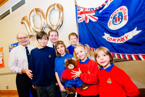 Company Lieutenant John Smith and Captain Luke Eggerton celebrate the 100th anniversary of the juniors' brigade with their group in 2017