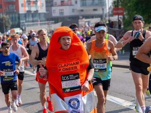 Man running in traffic cone costume