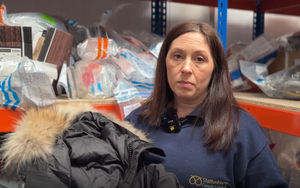 Trading Standards Officer Laura Burgess holding seized counterfeit goods.