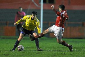 Charlie Barnett of AFC Telford United is challenged by Anthony Wright of Workington