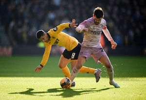 WOLVERHAMPTON, ENGLAND - JANUARY 10: Joao Gomes of Wolverhampton Wanderers is tackled by John Marquis of Shrewsbury Town during the Emirates FA Cup Third Round match between Wolverhampton Wanderers and Shrewsbury Town on January 10, 2026 in Wolverhampton, England. (Photo by Clive Mason/Getty Images)