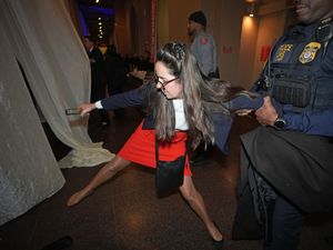 Woman grappling with a security officer