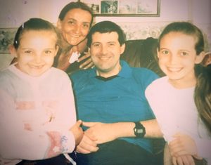Emily (left), with her mom Joanna, dad Laurence, and big sister Jessica.
