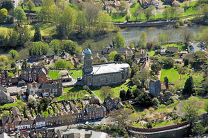 Bridgnorth High Town this picture shows St Marys Church in the sunshine with the old castle and its wall to the right