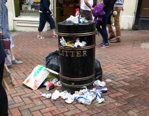 Rubbish spills onto Pride Hill out of an overflowing bin