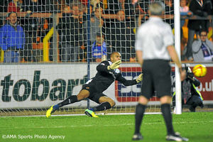 Carl Ikeme of Wolverhampton Wanderers dives as Liam Noble of Carlisle United scores a goal from a penalty to make it 2-2.