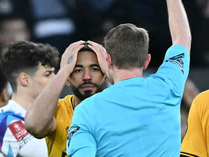 English referee Sam Barrott shows a red card to Wolverhampton Wanderers' Brazilian striker #10 Matheus Cunha (Photo by JUSTIN TALLIS/AFP via Getty Images)          