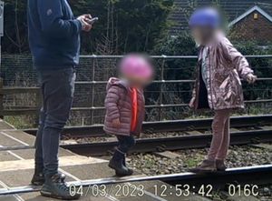 Supporting image for story: Shocking CCTV footage shows man letting toddlers play on railway tracks as train approaches
