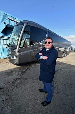 Nathan Hadley, MD at Prospect Coaches in Lye, next to the luxury coach used to transport the West Bromwich Albion first team