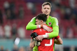 Wales' Neco Williams and Wales' goalkeeper Wayne Hennessey hug during the World Cup, group B soccer match between the United States and Wales, at the Ahmad Bin Ali Stadium in in Doha, Qatar, Tuesday, Nov. 22, 2022. (AP Photo/Darko Vojinovic).