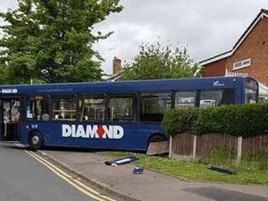 Supporting image for story: Bus smashes through fence into garden