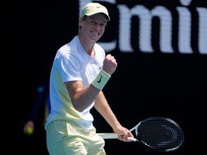 Jannik Sinner clenches his fist after winning a point