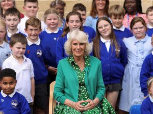 Supporting image for story: Queen presents children with books during primary school visit