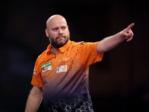 Christian Kist celebrates his nine-dart finish