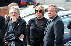 Daughter Elaine Costigan (centre) at her father's funeral