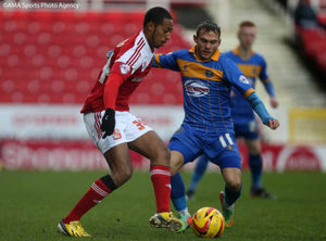 Jamie Reckord of Swindon Town and Jon Taylor of Shrewsbury Town