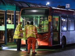 Police and National Express workers examine a bus after a man was hit in Dudley town centre. Photo: SnapperSK