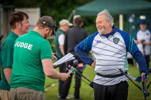 An archer speaking with official judges.
