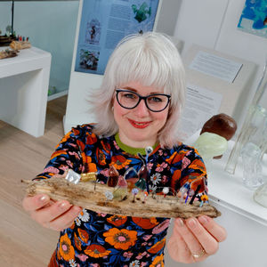 Terri Malcolm with her Driftwood workshop creations in the Greener Glass exhibition. Pic - Simon Bruntnell