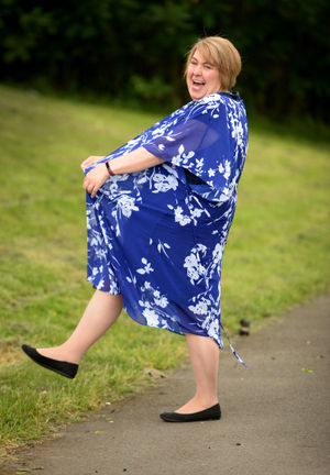 Julie Jenkins from Hartfields Way, Rowley Regis, celebrates losing 12 stone in 12 months. She is pictured wearing a dress that she used to wear before her weight loss