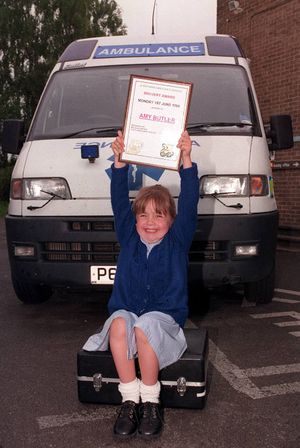 Amy received some certificates from Shropshire Ambulance Service at Shrewsbury after helping her mum in 1998