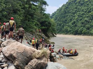 Supporting image for story: Rescuers recover first body after buses swept into river in Nepal
