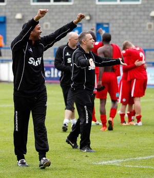 Larry Chambers, the assistant manager of Hednesford Town celebrates at the final whistle