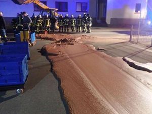 Supporting image for story: It’s a rocky road as a tonne of molten chocolate spills across street