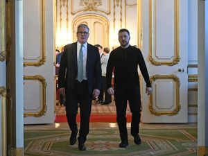 Ukraine’s President Volodymyr Zelensky and Prime Minister Sir Keir Starmer head to a private room to hold a meeting during a Leaders’ Summit on the situation in Ukraine at Lancaster House, London