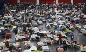 Evacuees escaping the floodwaters from Tropical Storm Harvey rest at the George R. Brown Convention Center that has been set up as a shelter in Houston