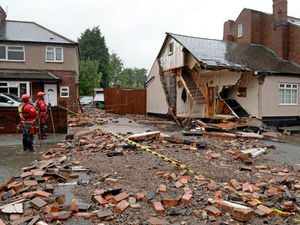 Supporting image for story: WATCH: Home damaged after burst water main floods road