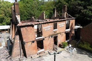 The burnt out remains of The Crooked House pub before it was demolished