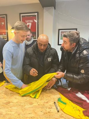 Carlos signing shirts at the pub