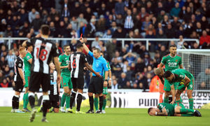 Sean Longstaff is shown a red card after a tackle on Wolverhampton Wanderers' Ruben Neves