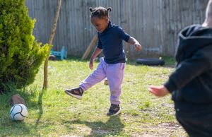 Children of Kids Planet Lawley playing with their new mini footballs