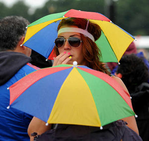 A girl braves the rain at V