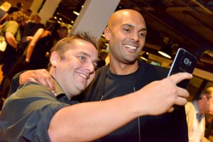 A fan grabs a selfie with Carl Ikeme 