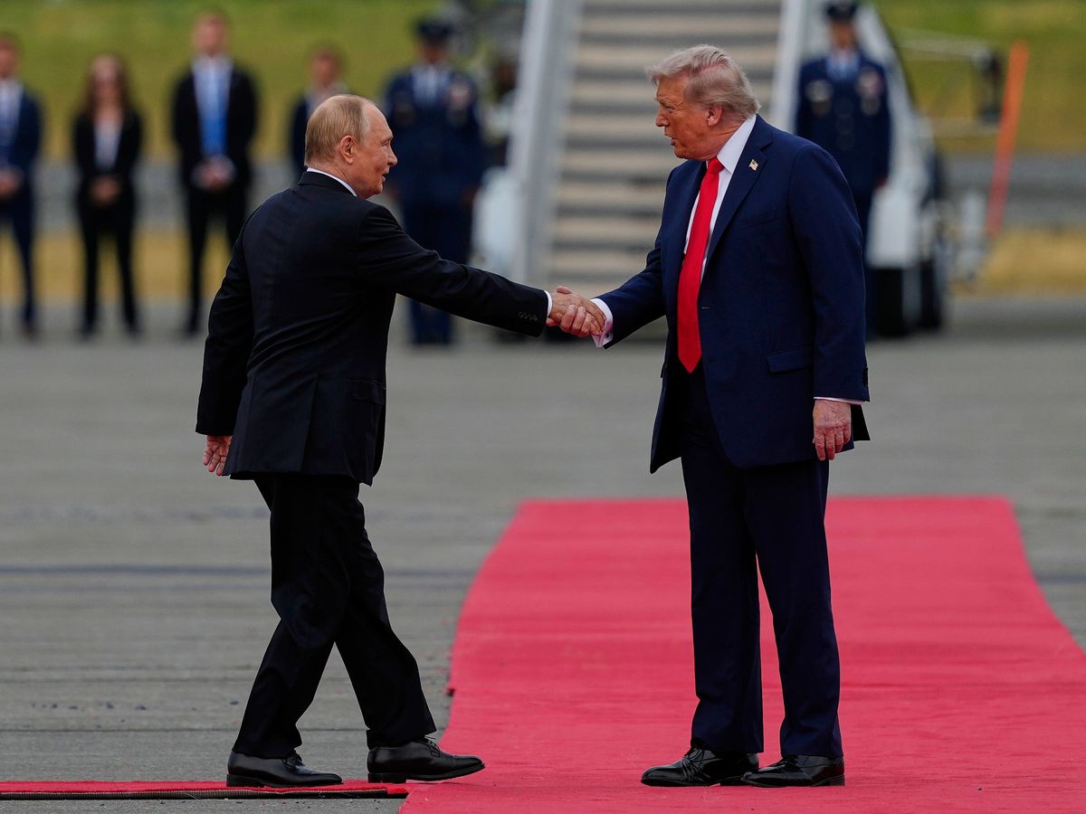 Donald Trump and Vladimir Putin shake hands on arrival for Ukraine war talks
