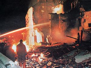 Firefighters hose down the smouldering ruins on the night of the blast.