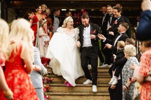 Brooke Evans, 30, in her wedding dress made by her brother Reagen Varross, 28, alongside her husband Alex, 35. Photo: Tony Hailstone Photography / SWNS